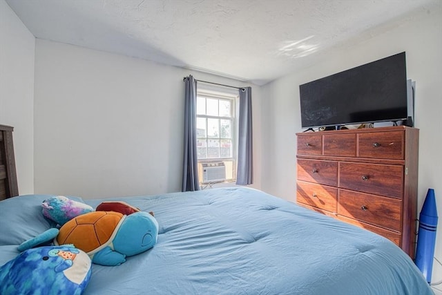 bedroom featuring cooling unit and a textured ceiling