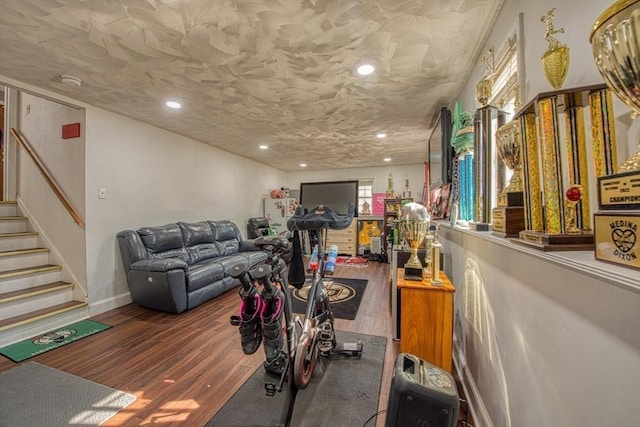 workout area featuring recessed lighting, baseboards, and wood finished floors