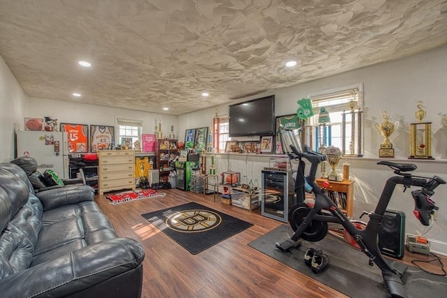 living area with recessed lighting and wood finished floors