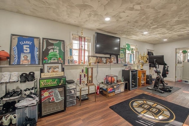 playroom featuring recessed lighting, wood finished floors, and a textured ceiling