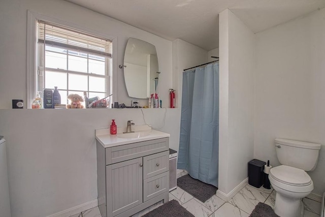 bathroom featuring curtained shower, baseboards, toilet, marble finish floor, and vanity