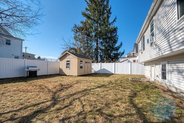 view of yard with a fenced backyard, an outdoor structure, and a shed