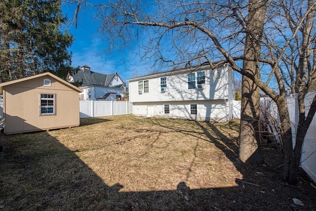 view of yard with a shed, an outdoor structure, and fence