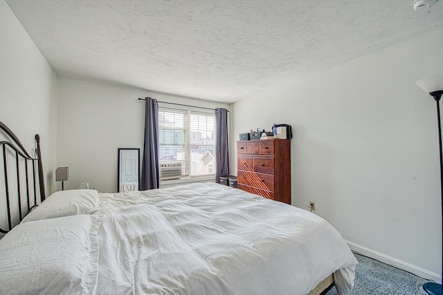 bedroom featuring baseboards and a textured ceiling