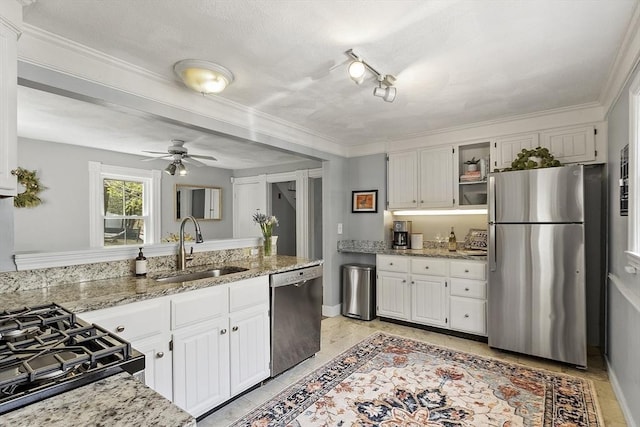 kitchen with stainless steel appliances, open shelves, white cabinetry, and a sink