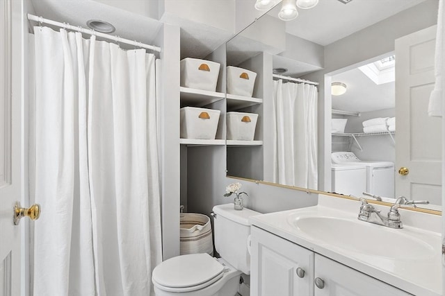 full bath featuring vanity, toilet, curtained shower, a skylight, and washing machine and dryer