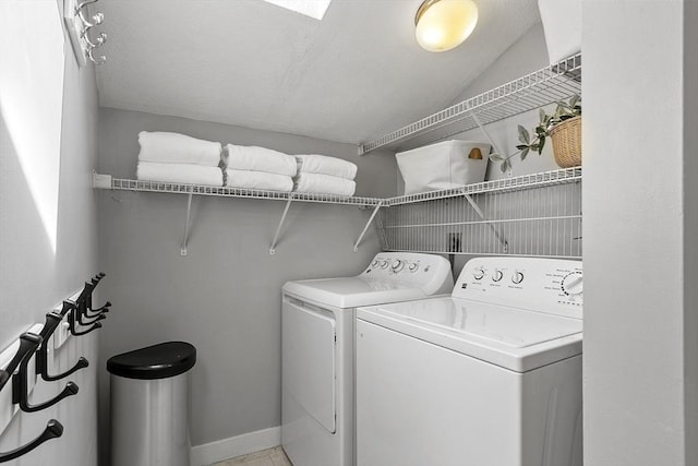 laundry area featuring laundry area, washer and clothes dryer, and baseboards