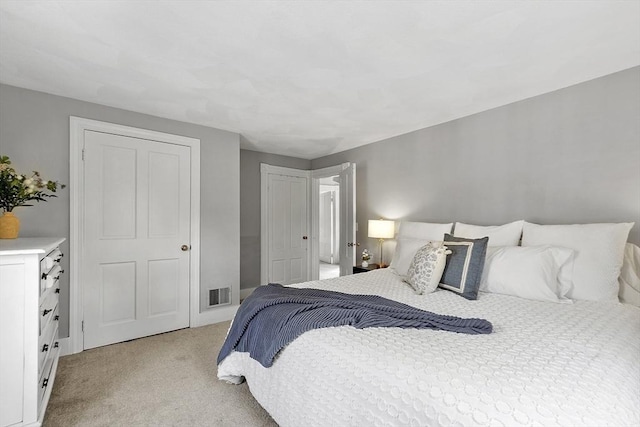 bedroom with light carpet and visible vents