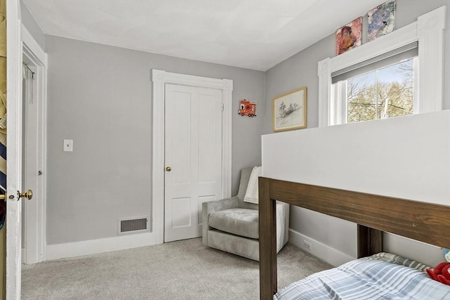 carpeted bedroom featuring baseboards and visible vents