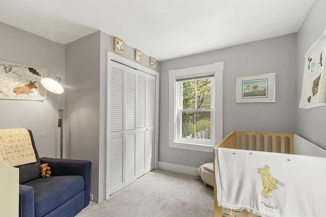 bedroom with a closet, carpet, and baseboards