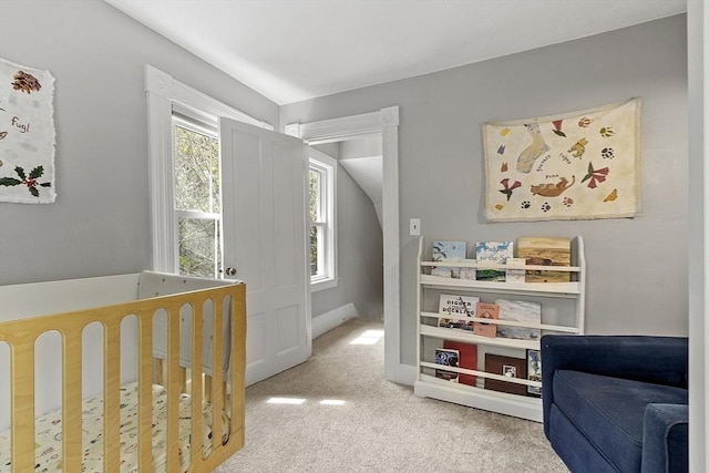 bedroom featuring carpet floors and a nursery area