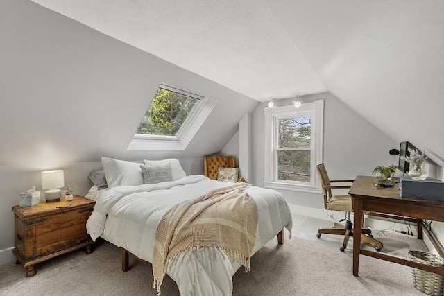 bedroom featuring carpet flooring and vaulted ceiling with skylight