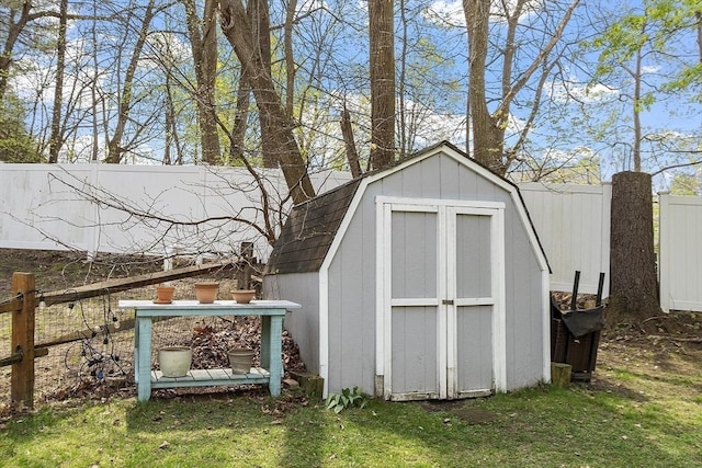 view of shed featuring fence