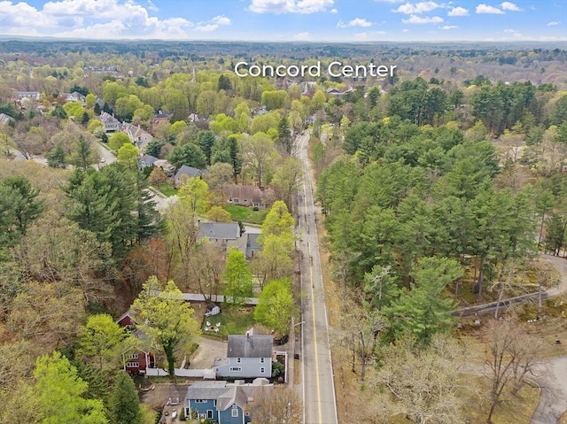 drone / aerial view featuring a forest view and a residential view
