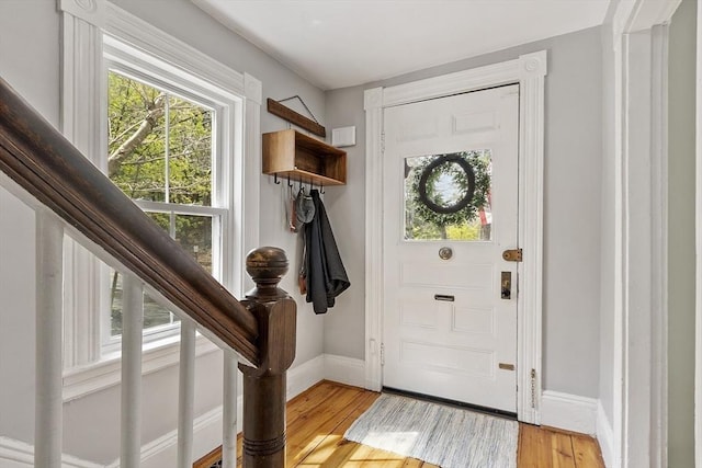 foyer featuring baseboards and light wood finished floors