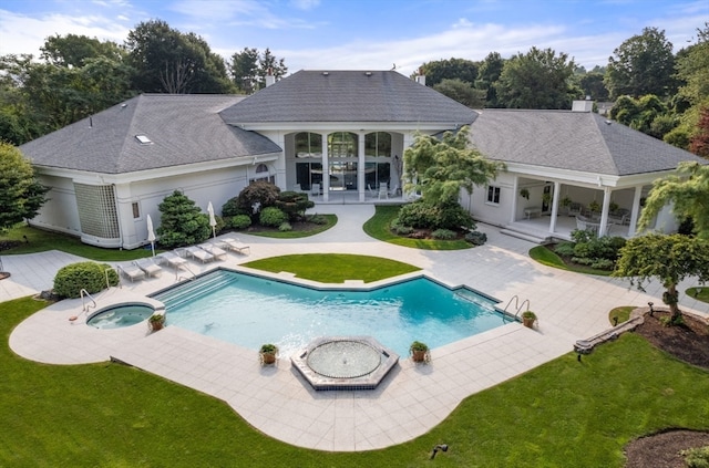 rear view of property featuring a patio, a pool with hot tub, and a yard