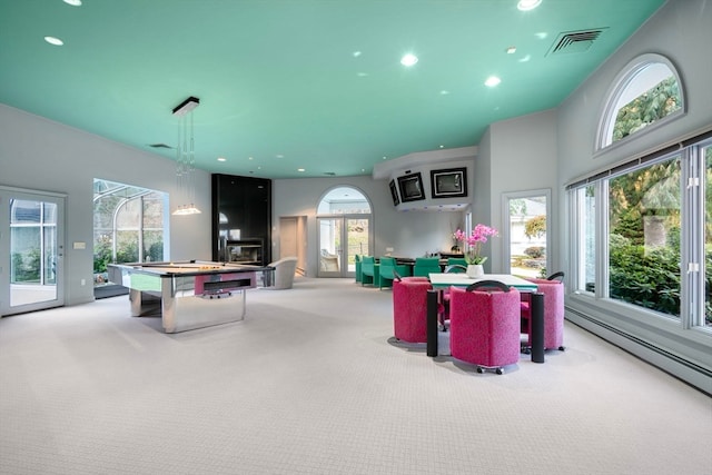 playroom with a wealth of natural light and carpet flooring