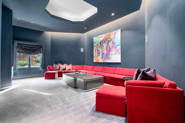 carpeted home theater room featuring a baseboard heating unit