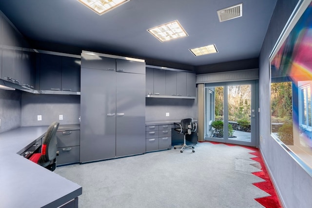 office area featuring built in desk and light colored carpet