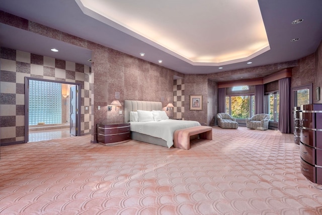 bedroom with light carpet and a raised ceiling