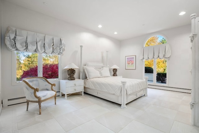 tiled bedroom with multiple windows and baseboard heating