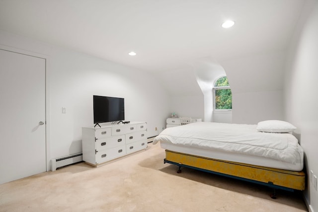 bedroom featuring a baseboard heating unit, light colored carpet, and vaulted ceiling