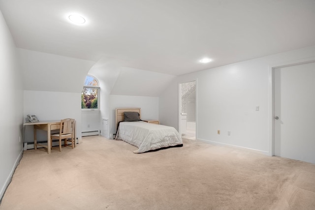 bedroom with a baseboard heating unit, vaulted ceiling, light carpet, and ensuite bathroom