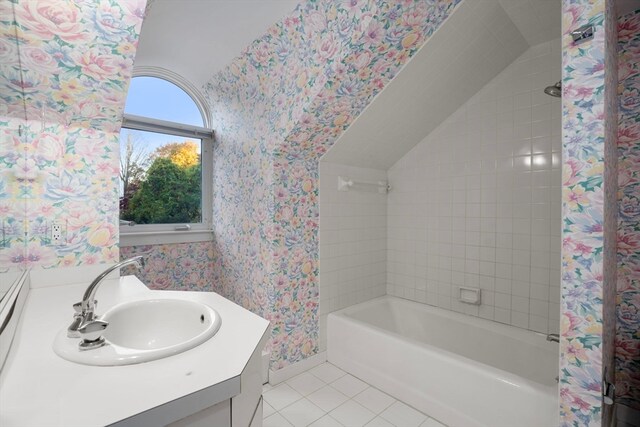 bathroom with vanity, tiled shower / bath combo, and tile patterned flooring