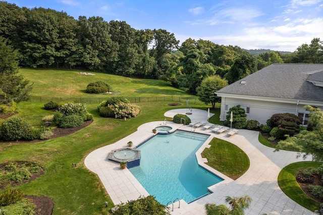 view of swimming pool featuring a yard, a patio, and an in ground hot tub