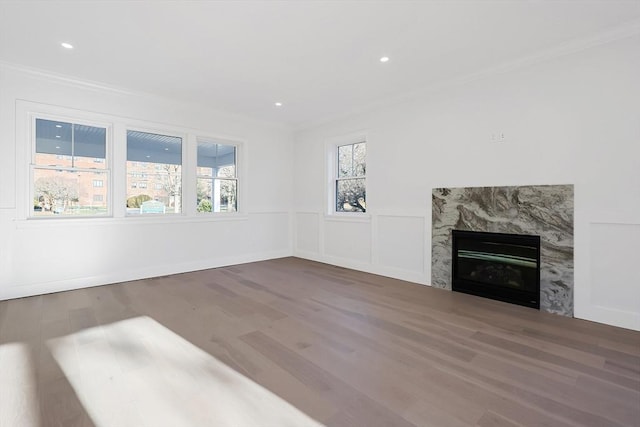 unfurnished living room featuring crown molding, hardwood / wood-style floors, and a high end fireplace