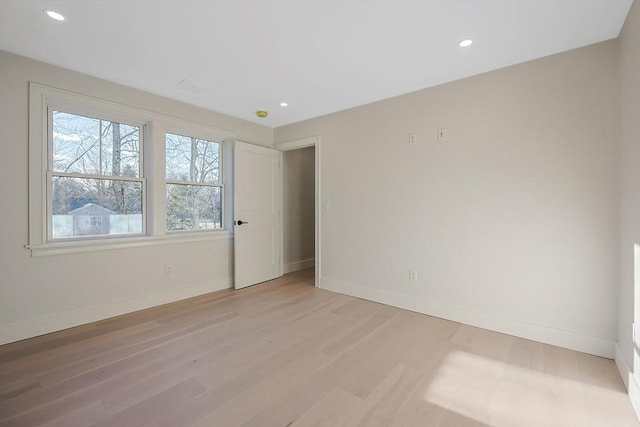 spare room with light hardwood / wood-style flooring