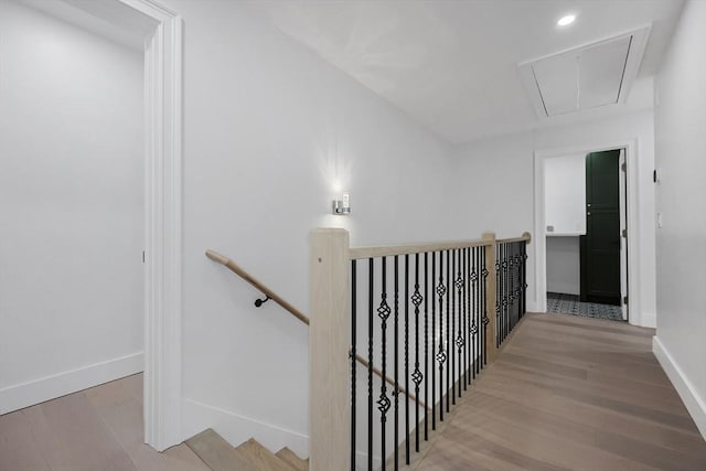 stairs featuring hardwood / wood-style floors