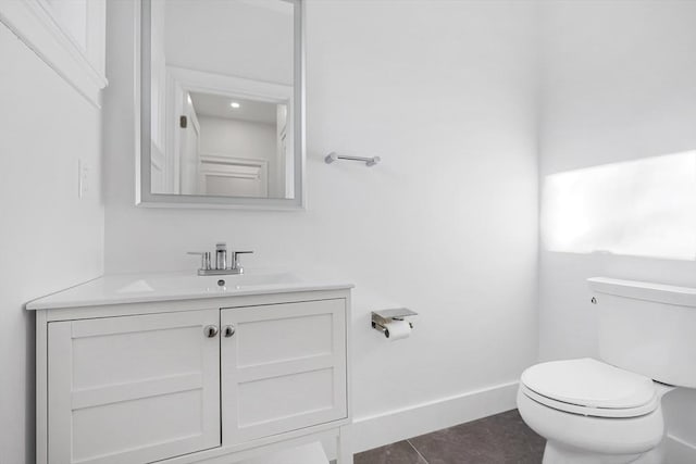 bathroom with tile patterned floors, vanity, and toilet