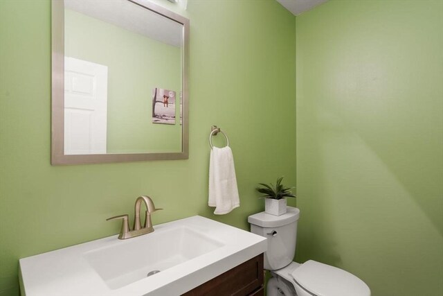 half bath with vanity and toilet