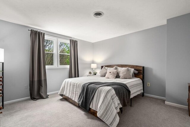 bedroom with visible vents, baseboards, and carpet floors