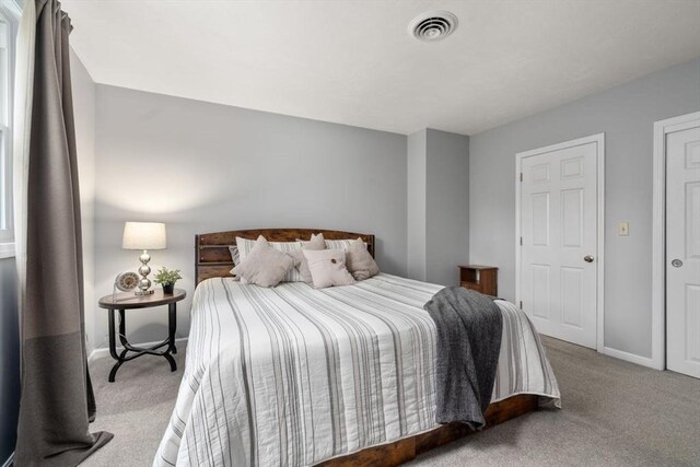 bedroom with baseboards, carpet, and visible vents