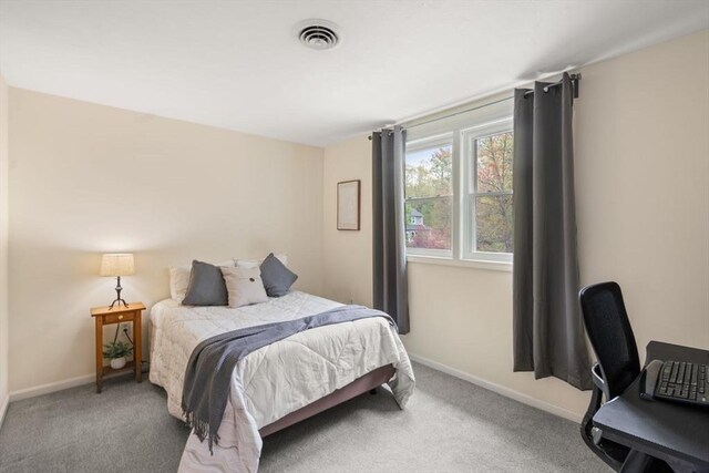 carpeted bedroom with baseboards and visible vents