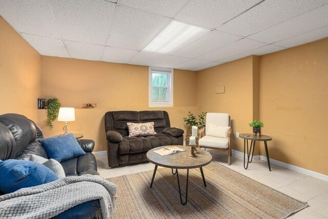 tiled living room featuring baseboards