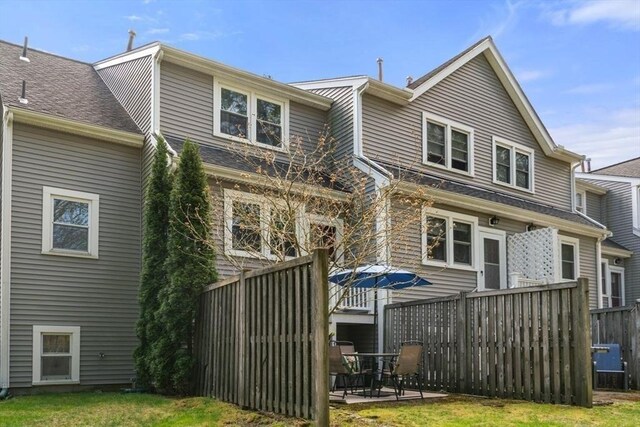 back of house featuring a patio area, fence, and a yard