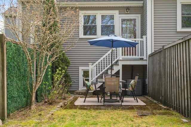 rear view of property with a patio and stairs