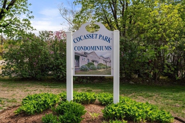 community / neighborhood sign with a yard