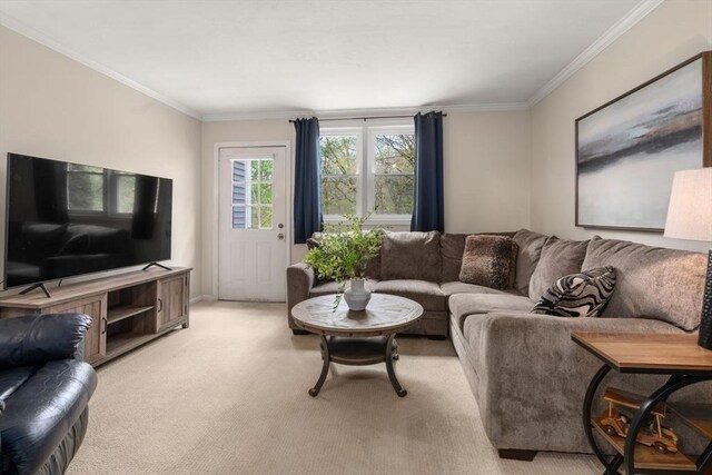living area with baseboards, ornamental molding, and light carpet