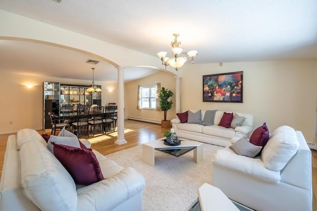 living room featuring an inviting chandelier, a baseboard radiator, light hardwood / wood-style floors, and ornate columns