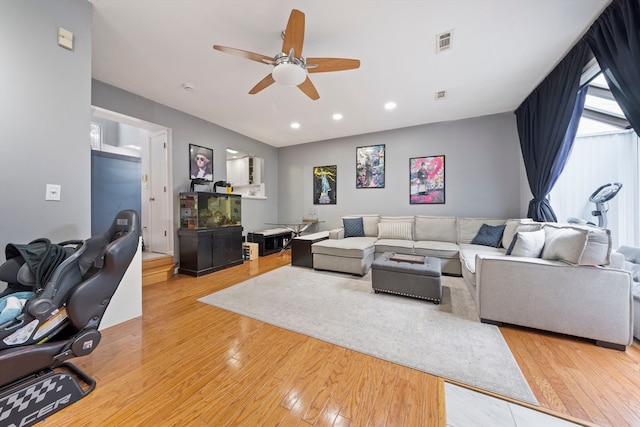 living room featuring hardwood / wood-style flooring and ceiling fan