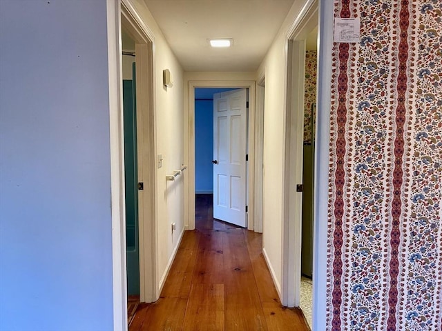 hall with hardwood / wood-style floors