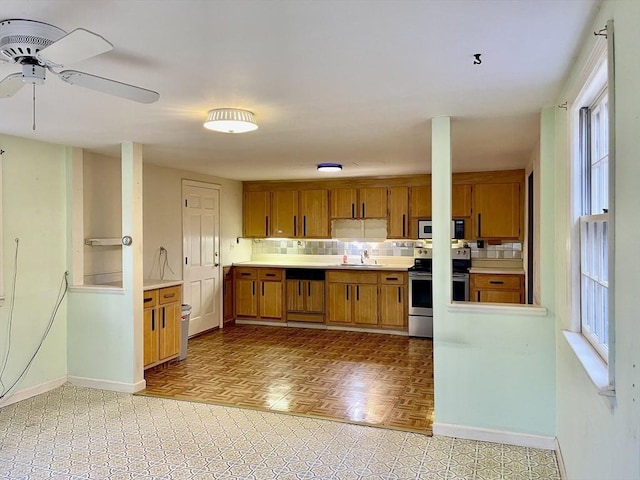 kitchen with decorative backsplash, plenty of natural light, and stainless steel appliances