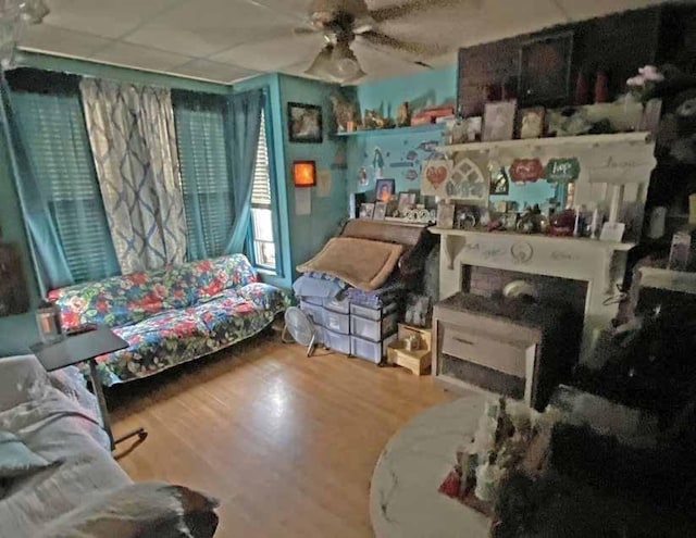 sitting room featuring hardwood / wood-style floors and ceiling fan