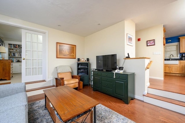 living room featuring hardwood / wood-style floors and sink