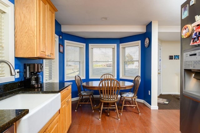 dining room featuring sink and dark hardwood / wood-style floors