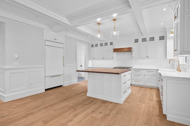 287 Cedar St, Chatham, MA 02633 - kitchen featuring paneled built in refrigerator, butcher block counters, coffered ceiling, premium range hood, and a kitchen island